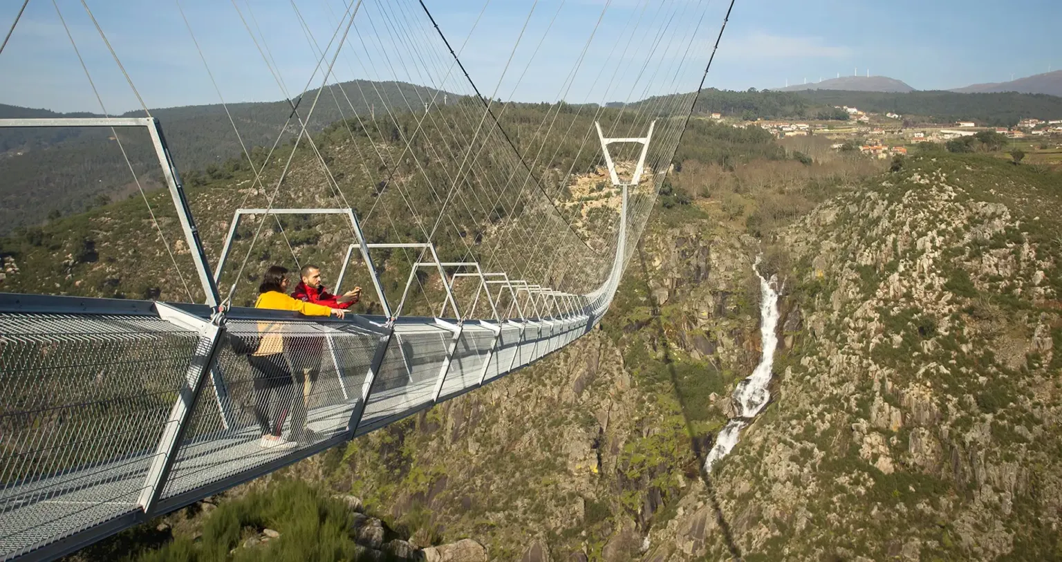 Person crossing the long suspension bridge above a gorge