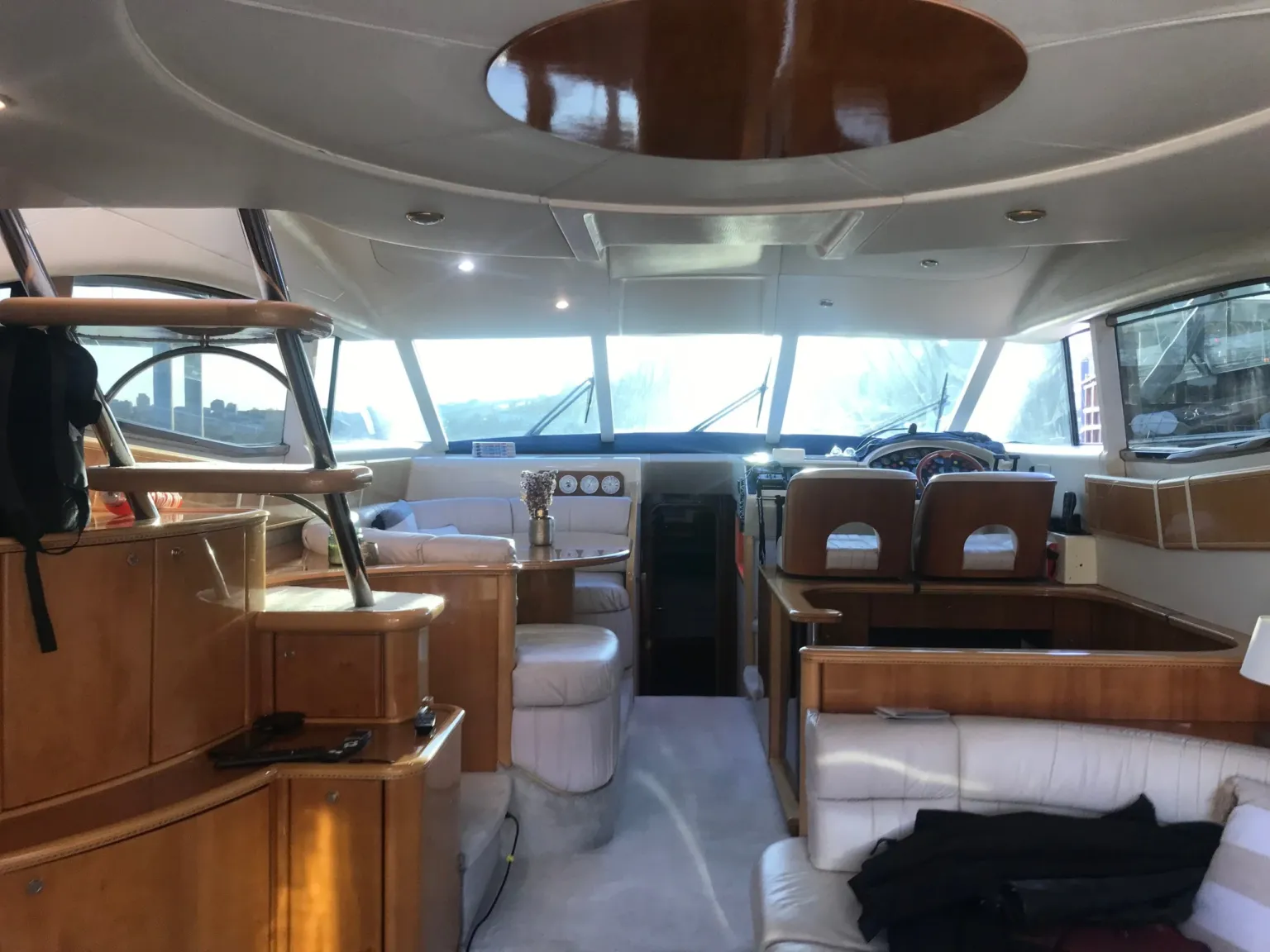 Interior of a yacht saloon with wood panelling and the helm