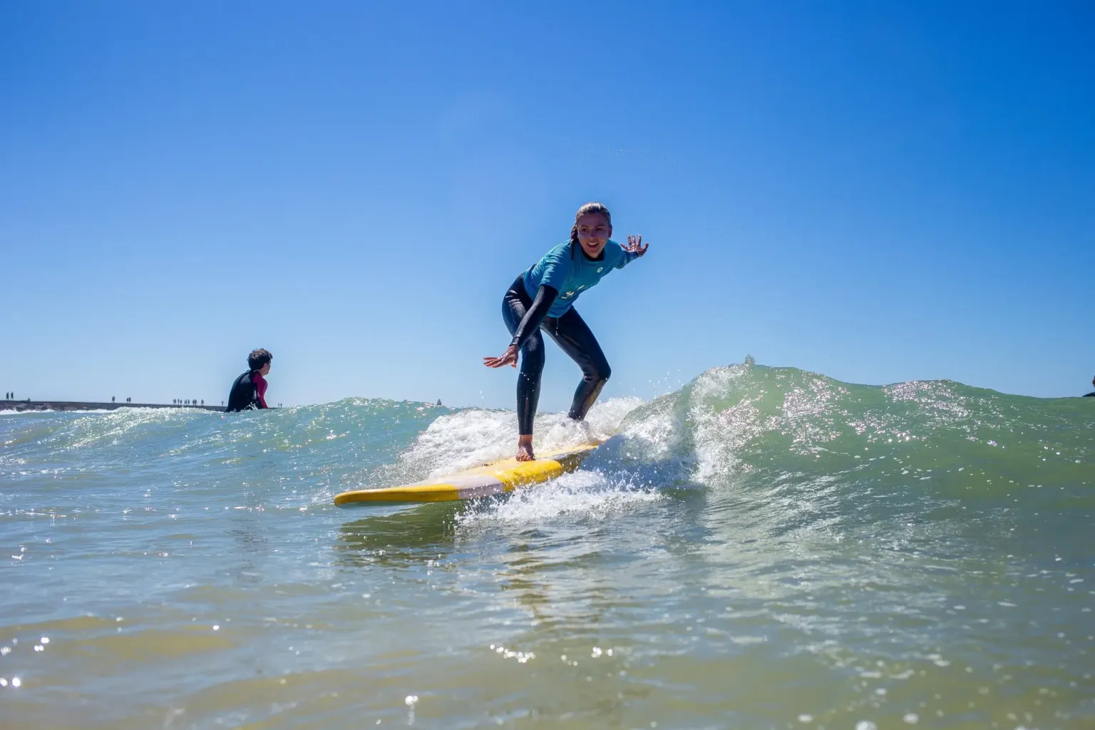 Surfer riding a wave on a yellow board