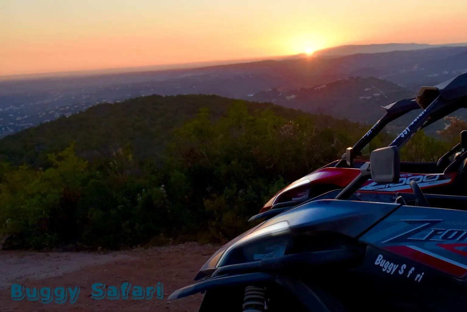 Buggy bonnet in the foreground as the sun sets over the hills
