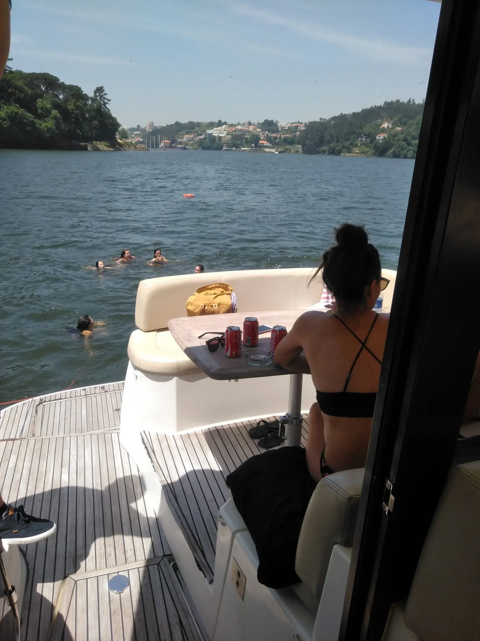 Woman sitting on the deck of a yacht on a river
