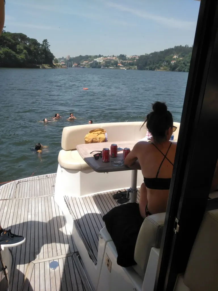 Woman sitting on the deck of a yacht on a river