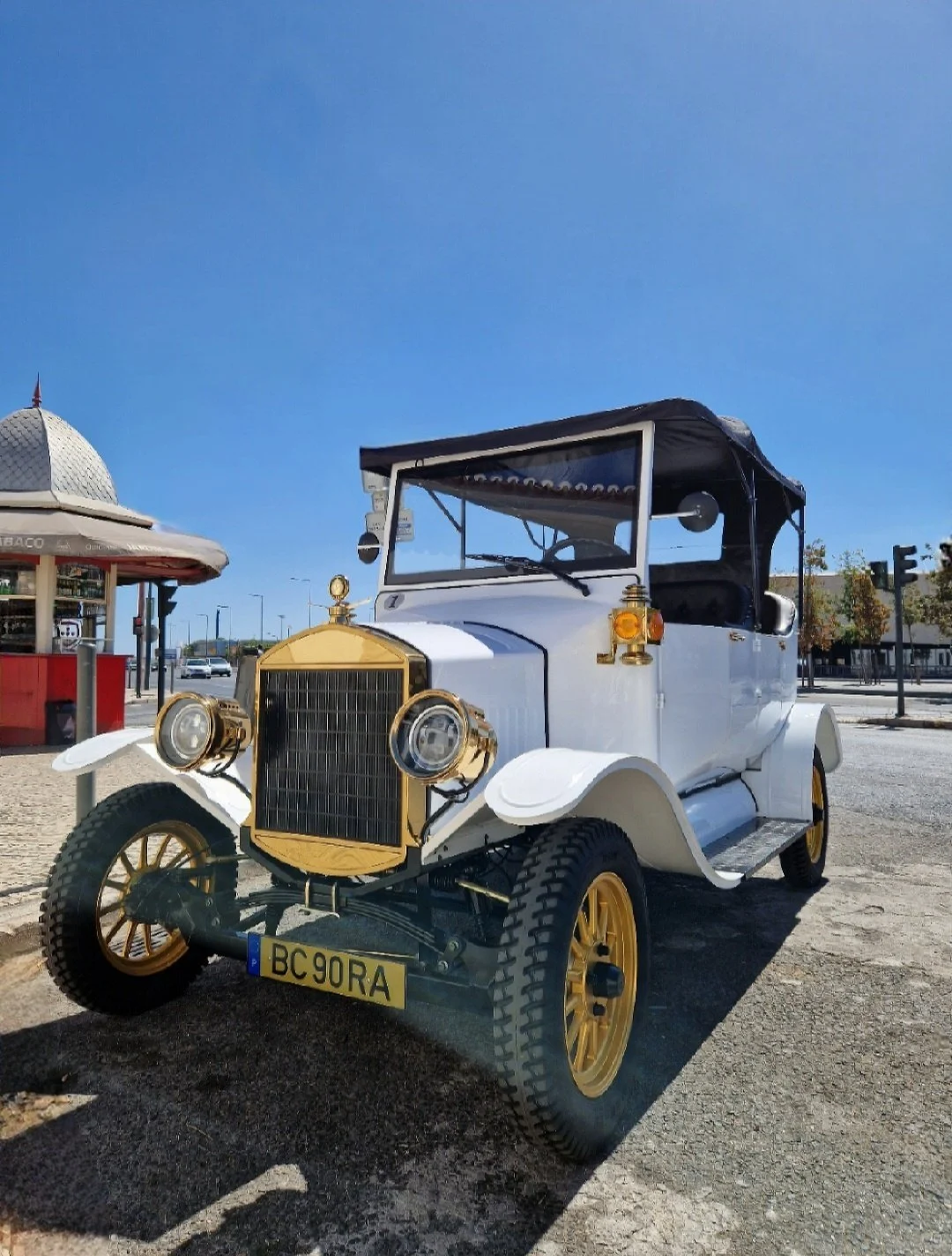 Klassieke witte cabriolet geparkeerd voor een kiosk