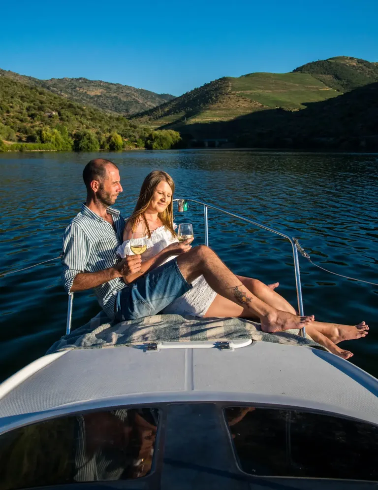 Couple relaxing on the bow of a boat on a river