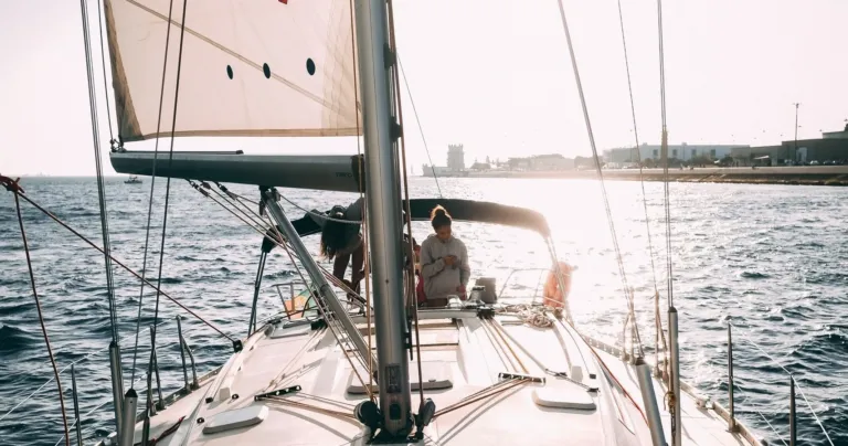 Sailboat deck and sails glowing in low sunlight