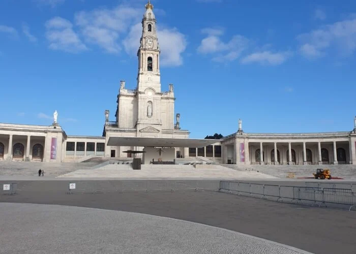 Basilica tower and colonnade of the sanctuary under a blue sky