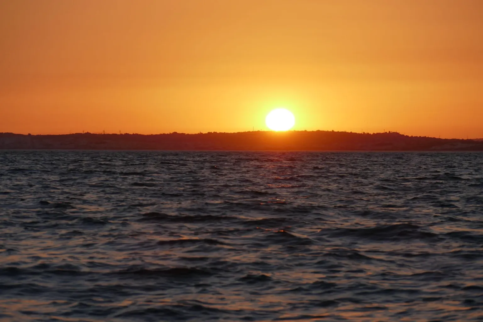 Sun sinking into the sea at sunset