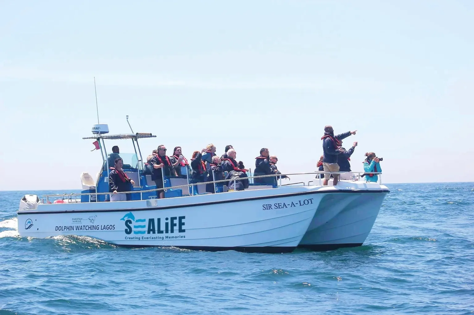 Catamaran named Sealife with passengers on deck at sea