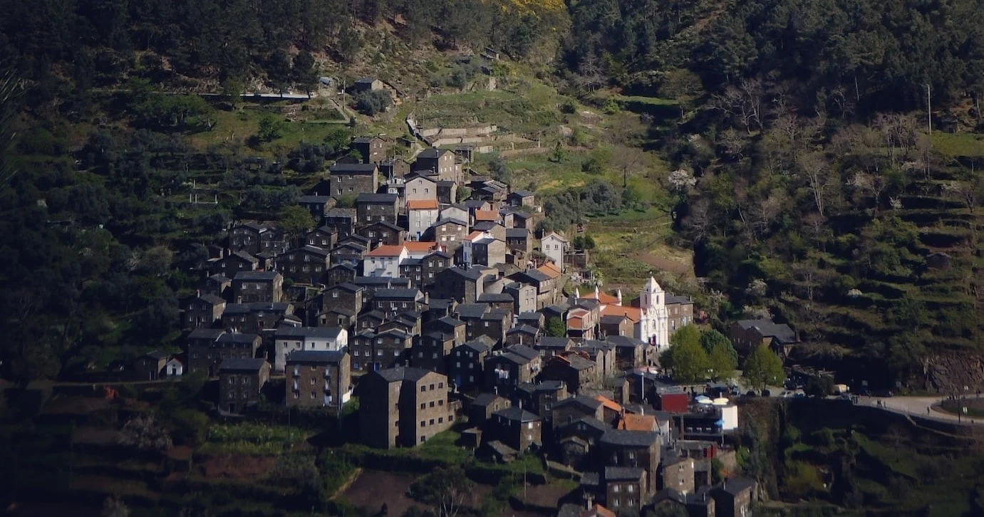 Stone village clinging to a terraced hillside