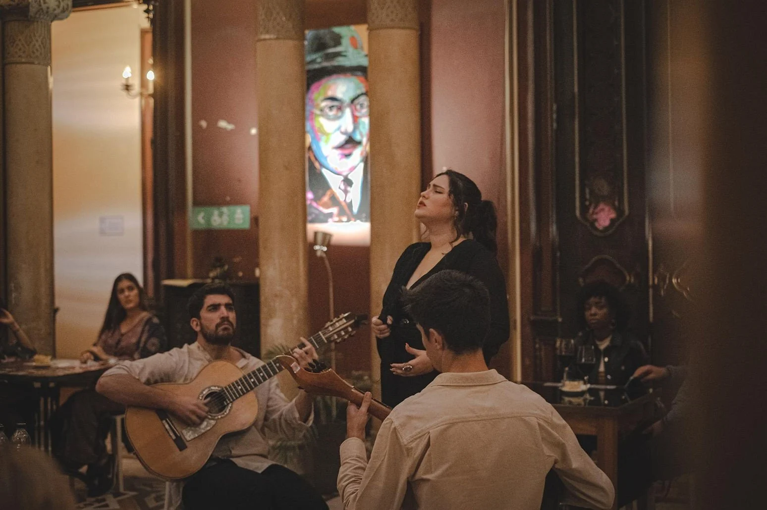 Singer and guitarist performing fado in a restaurant
