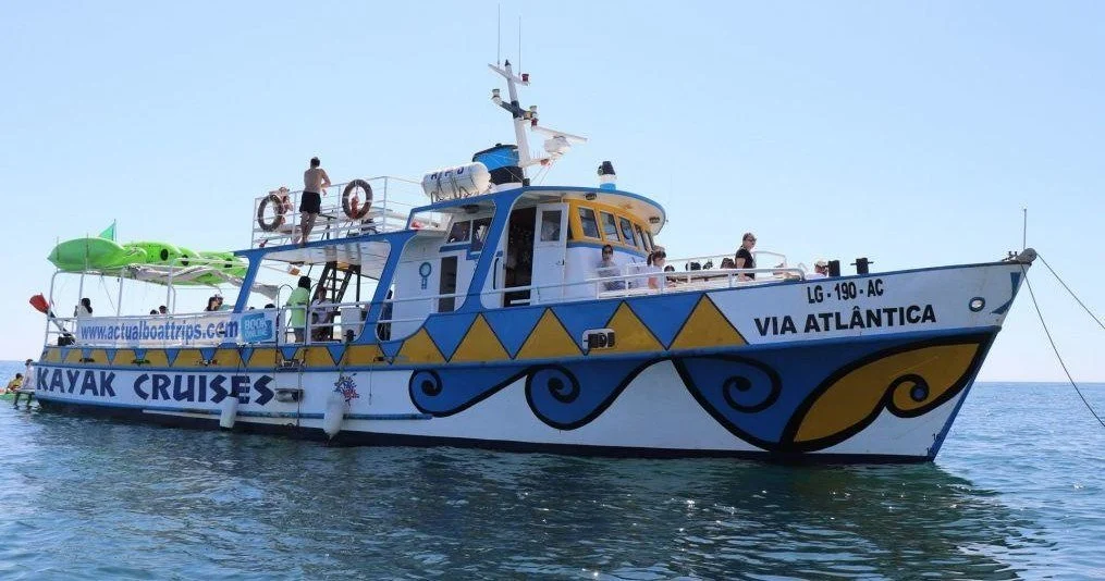 Blue-and-white kayak cruise boat named Via Atlântica at sea