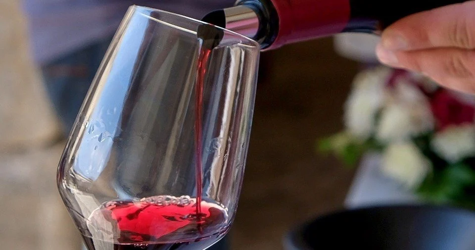 Red wine being poured into a glass