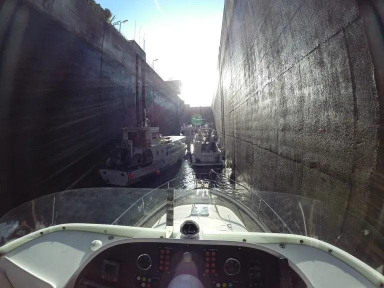 Yacht bow inside a large lock chamber