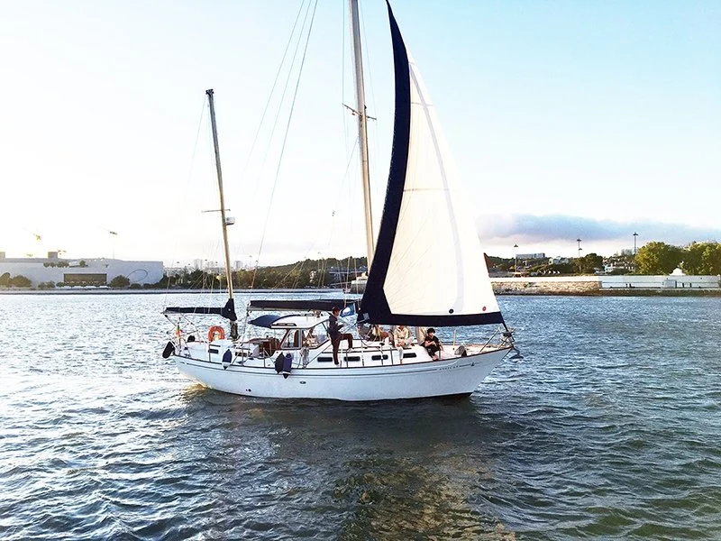 Classic sailing boat under sail on a river