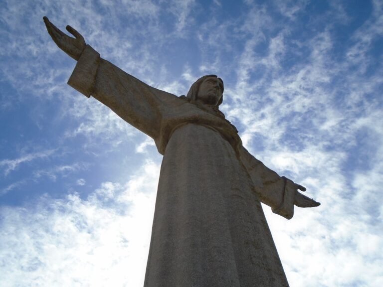 The Cristo Rei statue with open arms above the Tagus estuary